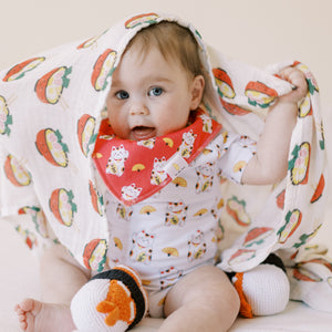 cute baby playing with the wee bean ramen swaddle