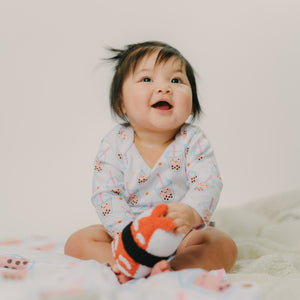 cute baby playing with the wee bean fair-trade handmade dolls in shrimp ebi sushi